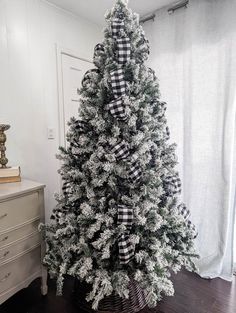 a white christmas tree with black and white bows