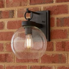 a light that is on the side of a brick wall