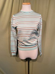 This is a sweet, vintage top from the 70s. Labeled, Touche' From Talbott.  Tagged a size 34. The bust measures 32" without stretching, see measurements below.   Made of blue & brick red nylon blend in a fine knit striped pattern. The top has a crew style neckline. It has long sleeves with ribbed cuffs & a ribbed band bottom hem. It has a good amount of stretch. Zips in the back with a nylon zipper. The top is in good condition!  No damage or wear. No soil or stains.  Classic!  Measurements were taken with the garment lying flat. If you have never worn vintage before, please measure yourself!! Vintage sizes run smaller than today's sizes, know your measurements before buying! Bust measured from side seam to side seam at the underarm: 16" unstretched for a 32" or slightly smaller or larger b Retro Crew Neck Sweater For Spring, Retro Blue Tops For Fall, Blue Retro Tops For Fall, Blue Retro Fall Tops, Retro Fitted Long Sleeve Sweater, Vintage Striped Sweater For Spring, Retro Red Sweater For Spring, Red Retro Sweater For Spring, Vintage Red Sweater For Spring