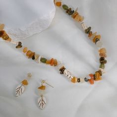 Embrace the enchantment of the season with our "Autumn Enchantment Gemstone and Pearl Necklace." Inspired by the ethereal beauty of forest nymphs in the heart of autumn, this unique piece captures the essence of nature's transformation. Crafted with Nature's Bounty: Handcrafted with a meticulous selection of natural stones, each one with its own unique shape, and lustrous pearls, this necklace is a testament to the treasures of the earth. The inclusion of delicate leaf elements adds a touch of w Jewelry Magazine, Pearl Necklace Earrings, April Birthstone Jewelry, March Birthstone Jewelry, Forever Jewelry, Pearl Gemstone, Fine Jewelry Gift, Cuff Earrings, Pearl Jewellery Earrings