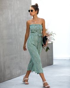 The EMES SHOP jumpsuit is detailed with a beautiful floral print. Features a tube design. tie waist belt. contrast button detail. and mid-calf length jumpsuit. Pair it with sandals and sunnies for a cute summer look.MATERIAL:100%Cotton MEASUREMENTS:JumpsuitsLength is 41"-43"in Small | Bust: 35"-37"in & Waist: 24"-26"in& Hip: 40"-42"in Medium | Bust: 37"-39"in & Waist: 26"-28"in& Hip: 42"-44"in Large | Bust: 39"-41"in & Waist: 28"-30"in& Hip: 44"-46"in X Large | Bust: 41"-43"in & Waist: 30"-32"in Casual Jumpsuits And Rompers With Tie Waist For Vacation, Belted Jumpsuits And Rompers For Spring Vacation, Summer Vacation Jumpsuits And Rompers With Belt, Chic Vacation Jumpsuits And Rompers With Tie Waist, Casual Strapless Jumpsuit For Summer Day Out, Casual Beach Jumpsuits And Rompers For Spring, Trendy Spring Vacation Jumpsuits And Rompers, Strapless Jumpsuit For Summer Beach, Sleeveless Belted Jumpsuits And Rompers For Day Out