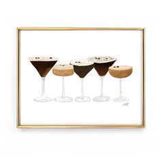 three martinis with different toppings are shown in a gold frame on a white wall