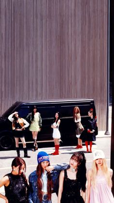 group of young women standing in front of a black van