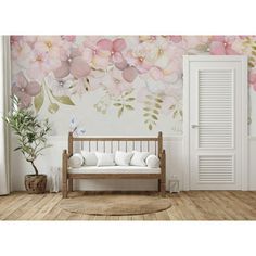 a room with flowers painted on the wall and a wooden bench in front of it