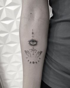 a woman's arm with an all seeing tattoo on it