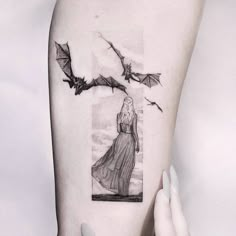 a woman's arm with a black and white drawing of a girl on it