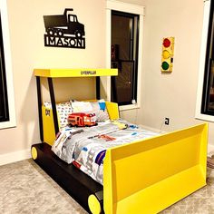 a child's bed made to look like a construction truck is shown in this bedroom