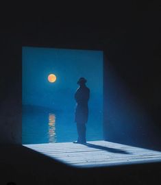 a person standing on a dock at night with the moon in the sky behind them