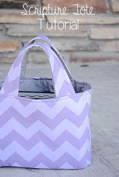 a purple and white bag sitting on top of a cement floor next to a brick wall