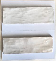 two pieces of white paper sitting on top of each other