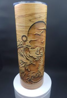 a wooden cup with an image of a fish on it