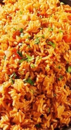 a bowl filled with rice and vegetables on top of a table