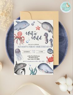 the under the sea birthday party is set up on a plate with an envelope and card