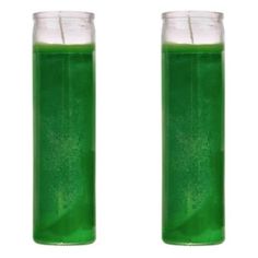 two glasses filled with green liquid sitting next to each other