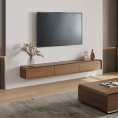 a living room with a large flat screen tv mounted on the wall next to a wooden coffee table