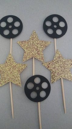 some black and gold stars are on sticks