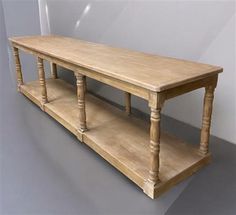 a wooden table with two shelves on each side