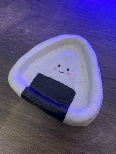 a rock with a towel on it sitting on top of a wooden table next to a blue light