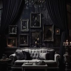 a living room with black walls and pictures on the wall, couches in front of them