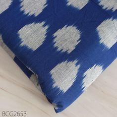 a blue and white pillow sitting on top of a wooden floor