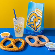 pretzels, milkshake and soft drink on a blue table