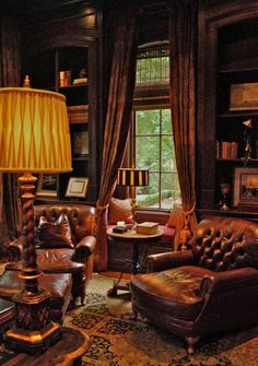 a living room filled with lots of furniture and a lamp on top of a table