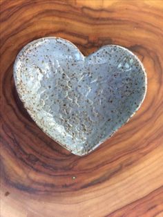 a heart shaped cookie sitting on top of a wooden table