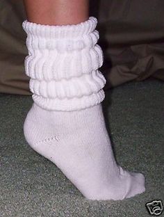 a person wearing white socks with ruffles on them