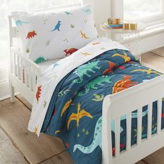 a child's bed with dinosaurs on it