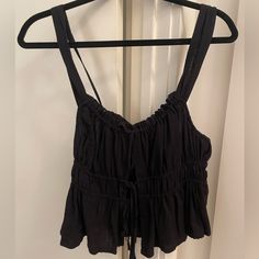 Black Camisole From Free People - No Longer Sold. Three Ties At The Front, Adjustable Ties On The Strap. Never Worn! Black Cotton Top With Tie Straps, Black Cotton Tops With Tie Straps, Black Summer Top With Tie Straps, Black Crop Top Camisole For Spring, Black Tank Top For Day Out, Black Fitted Tank Top With Tie Straps, Black Tank Camisole For Vacation, Black Tank Camisole For Day Out, Black Sleeveless Camisole For Day Out