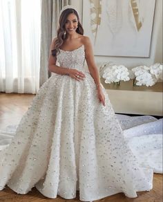 a woman in a white wedding dress posing for the camera