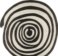 a black and white rug with an oval design on the center, in front of a white background