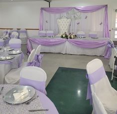 a banquet room with purple and white decor