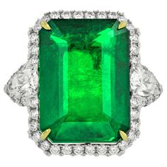 One GIA Certified Green Emerald and Diamond Ring, features 21.10 Carat Green Natural Emerald (GIA#2155900531), elongated emerald cut shape, certified by GIA Laboratory. Set with 3.40 Carats of diamonds, including two pear shaped diamonds on each side. Platinum Radiant Cut Diamond Ring, Emerald Cut Diamond Ring, Emerald And Diamond Ring, Platinum Diamond Rings, Emerald Diamond Ring, Fine Diamond Jewelry, White Gold Diamond Rings, Jewelry Rings Diamond, Buying Diamonds