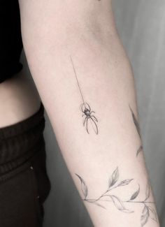 a woman's arm with a flower tattoo on the left side of her arm