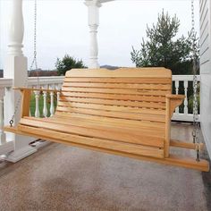 a wooden bench sitting on top of a porch