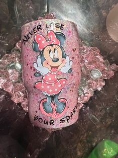 a pink cup with minnie mouse on it