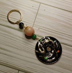 a keychain with an elephant and beads on it