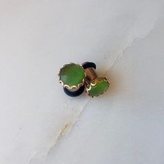 Beautiful and unique emerald colored tigers eye stone in a rose gold scallop setting. * 0g single flare in photo **available in sizes 8g-00g 3mm-10mm *I do not recommend swimming or showering in plugs. *quantity 1:1 pair *please allow 5 business days for processing time, unless rush+priority is chosen at checkout and item will be in the mail with 2 day shipping with 24-48hrs (US only) Tigers Eye Stone, Green Tiger Eye, Dangle Plugs, Stone Plugs, Earthy Jewelry, Plug Earrings, Woodland Park, Black Gems, Sister Jewelry