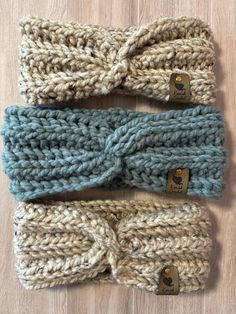 three crocheted headbands on top of a wooden table