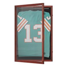 a football jersey in a wooden display case with the number 13 on it's chest