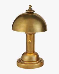 an antique brass table lamp on a white background