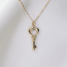 14K gold heart key necklace 14K gold heart key charm is about 18mm x 8.5mm 14K gold 1 mm diamond-cut cable chain All components are 14k gold Classic Jewelry With Keys For Gifts, Elegant Heart-shaped Necklace With Two Keys, Elegant Heart-shaped Key Jewelry, Elegant Two Keys Necklace As Gift, Elegant Two Keys Necklace Gift, Elegant Two Keys Necklace For Gift, Luxury Gold Jewelry With Keys, Gold Heart Necklace With Two Keys, Valentine's Day Heart Pendant Jewelry With Two Keys