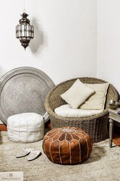 a living room filled with lots of furniture and decor on top of a carpeted floor