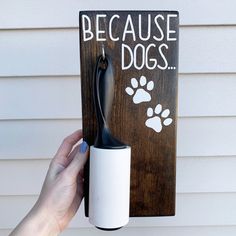 a hand holding a cup holder with a dog paw print on it and the words because dogs are not allowed