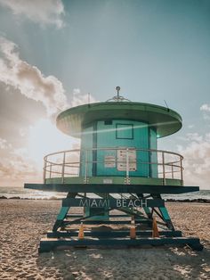 a lifeguard tower sitting on top of a sandy beach