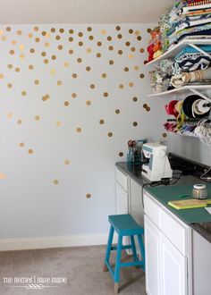 a sewing room with gold polka dots on the wall