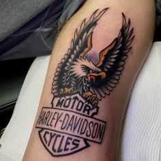 an eagle with the words harley davidson cycles on it's left arm and back