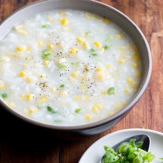 a bowl of soup with corn on the side