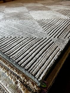 a close up of a bed with a blanket on top of it